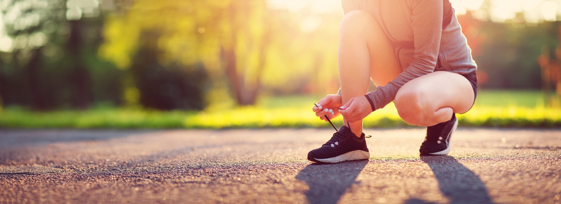 Young woman running in the park. Active person outdoors at the dusk in summer